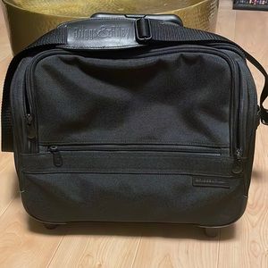 Briggs and Riley rolling bag. Has waterproof pocket for wet stuff.